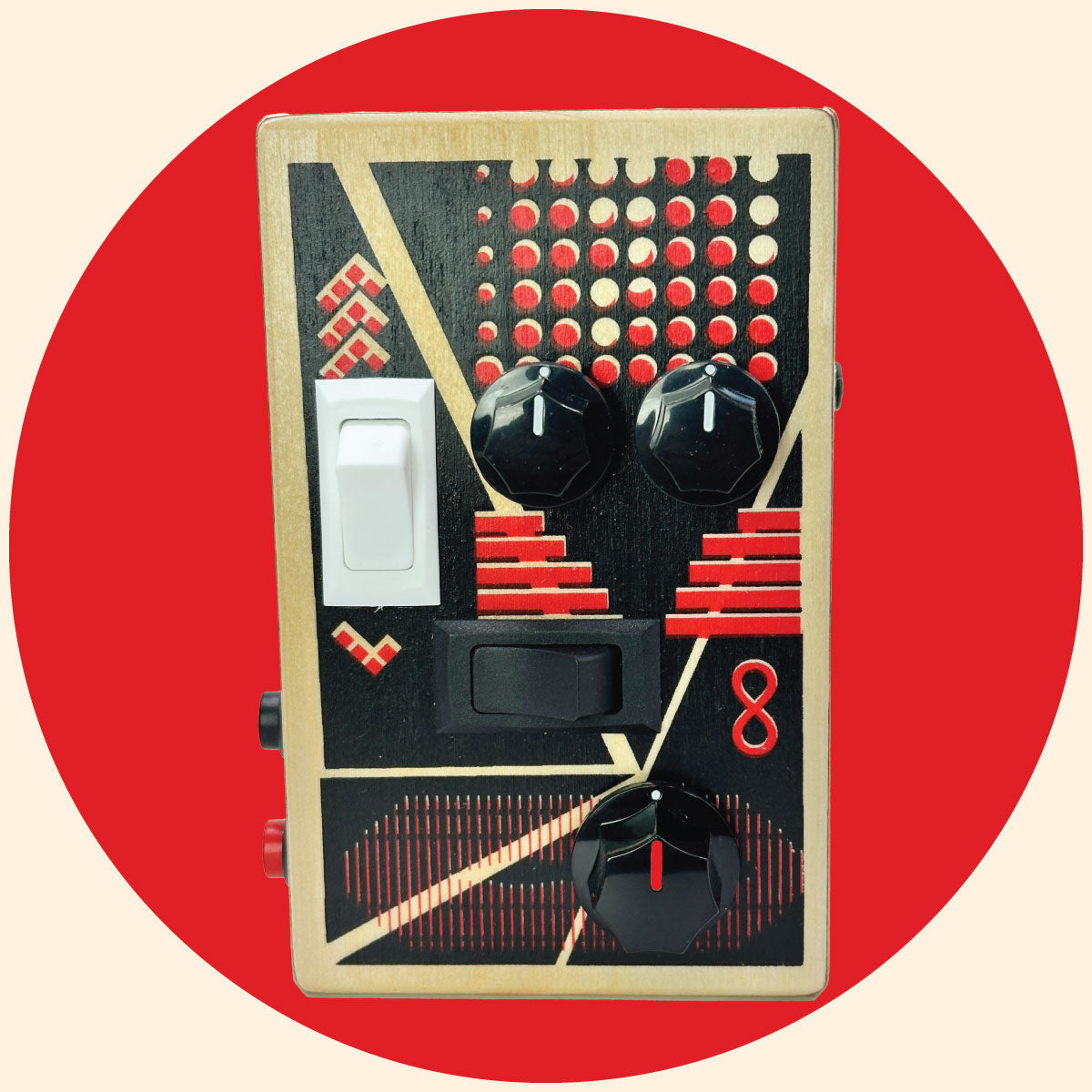 BrandNewNoise sound  gadget with red and black art design, black control knobs, white and black rocker switches